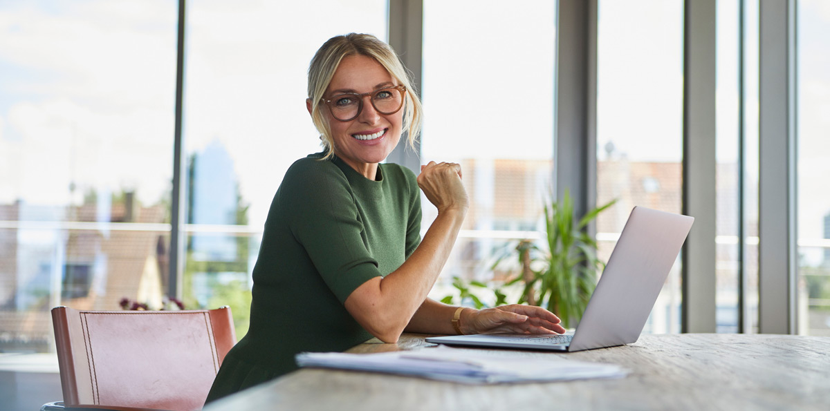 Woman with laptop sitting at desk